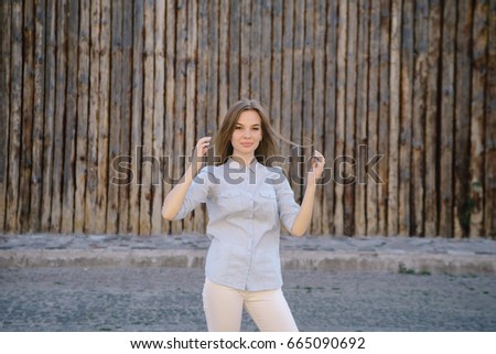 cute girl against old wooden fence background