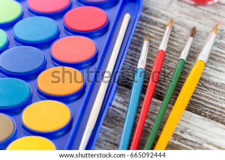 paint brushes on wooden background, special tools for creative people, back to school, education background,