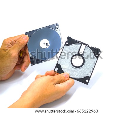 The hand man hold floppy disk  and show Inside floppy disk.