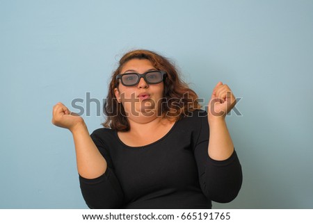 young woman watching a movie wearing 3d glasses