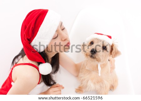 pretty girl and dog in santa hat at Christmas