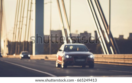 Cars driving on bridge road, de focused blurry photo