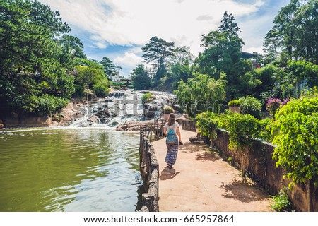 Young woman on the background of Beautiful Camly waterfall In Da Lat city,