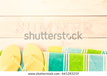 Bright women's flip flops with beach towel.