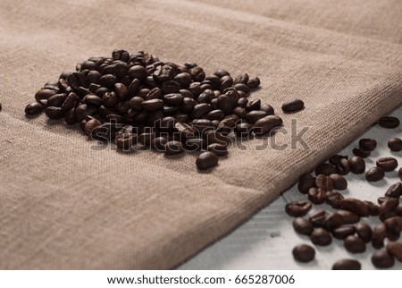 Coffee beans on sackcloth background, the old wooden background