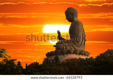 Buddha statue over scenic sunset sky background