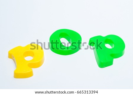 The word pop is lined with magnetic letters of yellow and green on a white background