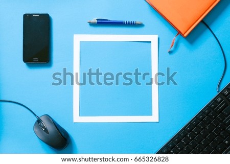 Top view blue desk table. Office tools on colored background. Flat lay of workspace
