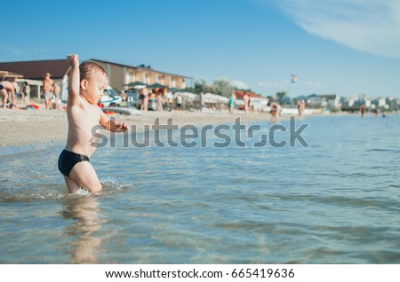 Little boy child swimming in the sea. bathing in sea water. Summer vacation holiday vacation.