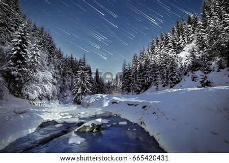 Winter night with trails and mountains