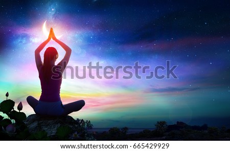 Woman Doing Yoga With Lotus Flowers And Chakra Gradient Colors - Spiritual Contemplation 
 Royalty-Free Stock Photo #665429929