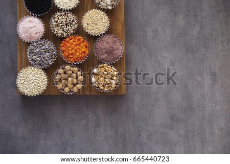 Various superfoods, seeds, cereals, grains on a gray background. Healthy eating concept. Top view