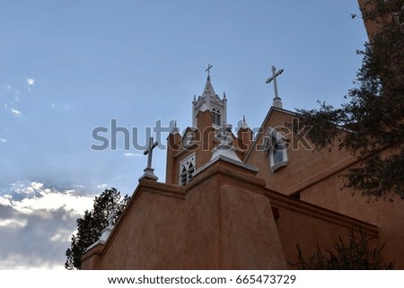 Catholic church with many crosses and blue sky background 