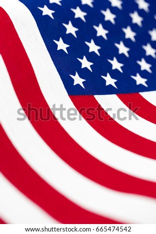 Rippling flow of stars and stripes of flag of the United States in close up, vertical format background