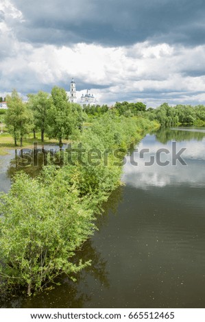 Orthodox church Flood. Natural disaster - the flooding of the land with water, which originated from the coast. Trees of bushes are in the water. Receipt of insurance benefits