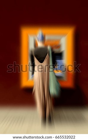 Woman withdrawing money from an ATM cash machine,intentionally blurred photography.