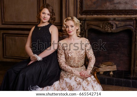 Mother and daughter in classical interior