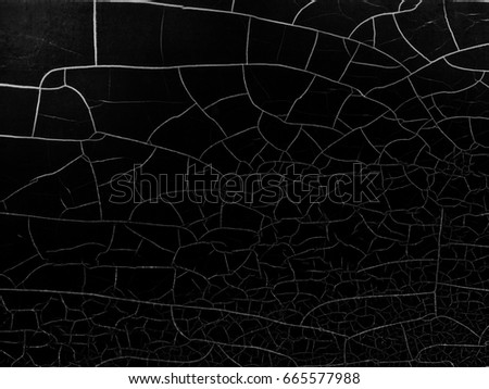 Abstract background of Cracks surface black and white toned.