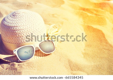 Hat and sunglasses on the beach