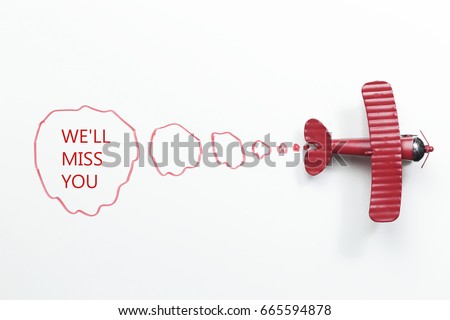 writing We'll Miss You red toy airplane with talk bubble on white background Royalty-Free Stock Photo #665594878