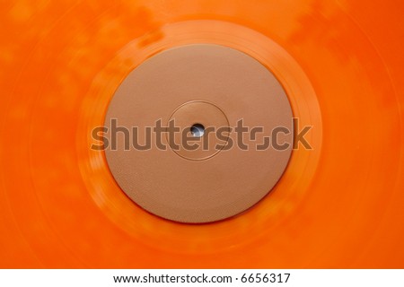 Colored orange vinyl record detail. Abstract background.