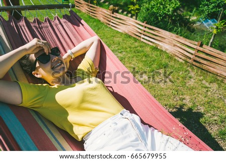 young pretty woman rest in hammock in sunny day