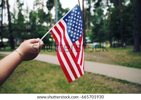 People Holding the Flag of USA. Fourth of July Independence Day, Patriotic holiday, American flag.
