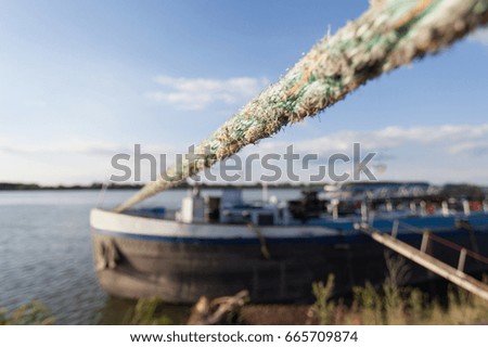 anchored boat tied with heavy duty rope