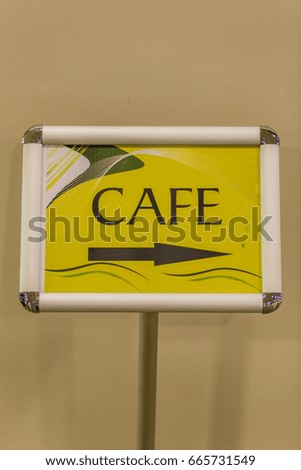 The inscription and the index is a cafe. The arrow indicates the direction where to go if people want to eat.