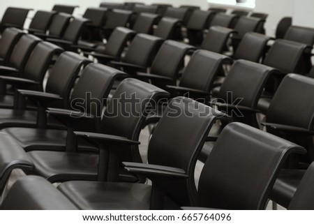 Lecture audience. Empty black chairs