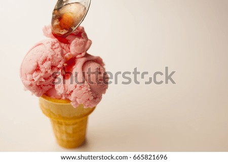 Strawberry ice cream drizzled with berry sauce