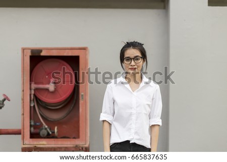 woman in white T shirt stand with Fire extinguishers
