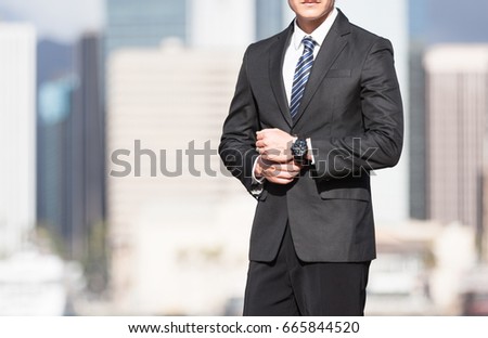 Man in suit against a city background. 
