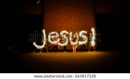 Time Lapse Photography. The word Jesus done in sparklers.