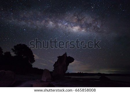 Milky Way view from Kudat, Sabah, North Borneo. The Milky Way Galaxy and guardian stone. Long exposure and high ISO night photography. Image may contain grain, noise and blur.