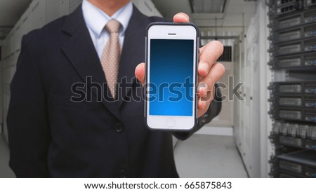 Programmer in server room and smart phone
