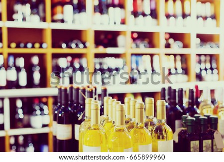assortment of different wine bottles in retail wine store
