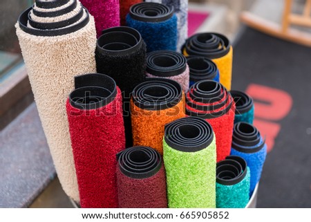Lots of colorful rolled up carpets Royalty-Free Stock Photo #665905852
