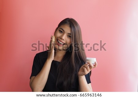 Beautiful Asian woman applying powder
