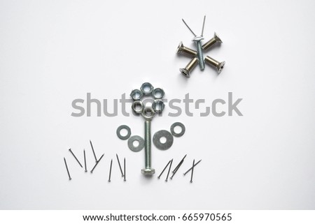 Steel bolts. Tools in the shape of a flower and a butterfly. Wrenches, nuts and bolts on plain background. Bolts, nuts, screws, nails.