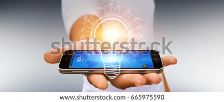 Businessman on blurred background holding renewable eco lightbulb sketch