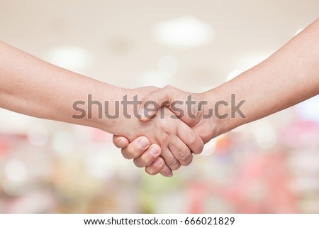 hand shake over blur background Royalty-Free Stock Photo #666021829