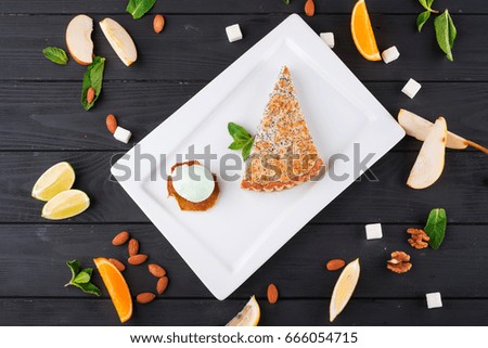 Poppy pie with mint ice cream on a wooden dark background
