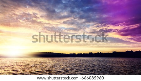 fantastic colorful landscape.  overcast clouds glowing in sunlight at sunset over the lake. picturesque view. color in nature. natural creative picture. vintage style. instagram toning