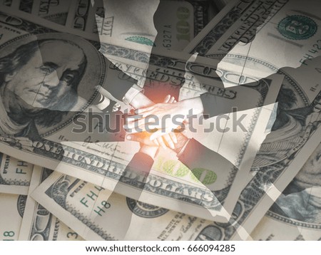 Concept of teamwork,business six worker joined hands on money background (grain in picture)