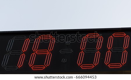 Electronic  clock with red illumination and the time 18:00