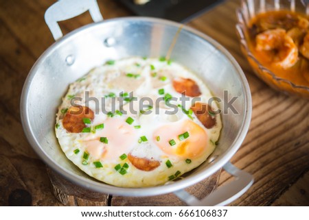 Panned egg top with sausage, traditional asian style breakfast for morning.