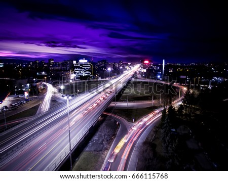 Night aerial view of a main boulevard, a roundabout, office buildings and long exposure car tail lights at Tsarigradsko shose in Sofia, Bulgaria