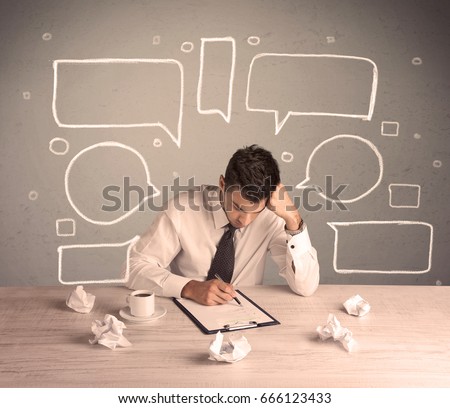 An intelligent elegant business person sitting at a desk and working with drawn empty text bubbles, boxes around him concept