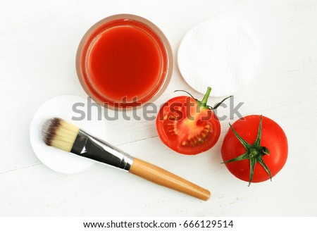 Tomato face mask for natural beauty care. Jar of juicy paste, red fresh fruit, applicator brush, top view white wooden background preparation homemade cosmetic   Royalty-Free Stock Photo #666129514